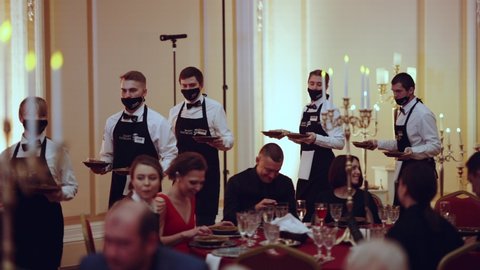 Nizhny Novgorod, December 10, 2021. Waiters carry food in the banquet hall of the restaurant