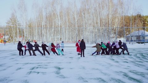 Nizhny Novgorod, December 26, 2021. Winter fun and games for a group of adults, tug of war in winter