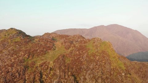 Haystacks. Lake district. England. May. 29. 2021. Flying away from a mountain summit in the morning drone footage