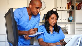 Doctor and nurse check patient data in hospital computer database. High quality 4k footage - Powered by Shutterstock - Get 15% off with code: PIKWIZARD15