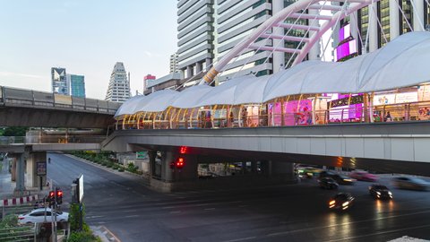 Chong Nonsi Intersection, Bangkok, Thailand-December 31.2021. Timelapse Video 4K. Long exposure twilight of vehicle on road. Skywalk Courtyard decorated with lights surrounding places during dusk.