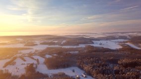 High above flight over winter forests and fields, 4k AERIAL.
