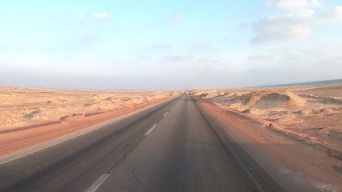 Timelapse of driving on the road in the desert of Egypt. Conceptual for vacation, enjoying the journey on an empty road