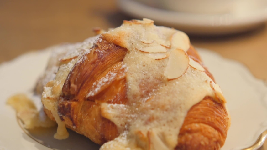 Close up of tasty Swedish style french croissant topped with frosting in a traditional restaurant.