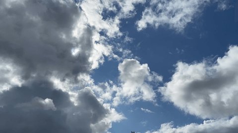 A moving fast forward video of cloud formations passing by on a blue sky 
