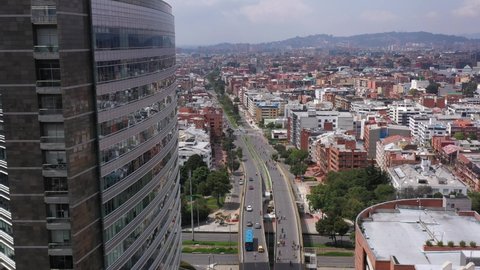 View from a drone of a street with a bridge and a bike path in the city of Bogotá.