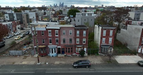 Aerial of unsafe condemned housing in USA. Poverty in urban America. Trash on sidewalk. Slumlord home apartment building for poor inner city population lifestyle.