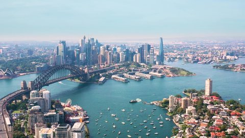 SYDNEY, NSW, AUSTRALIA – DECEMBER 18, 2021:  Aerial drone pullback view of Sydney CBD with Sydney City, the Sydney Harbour and Harbour Bridge looking over Lavender Bay