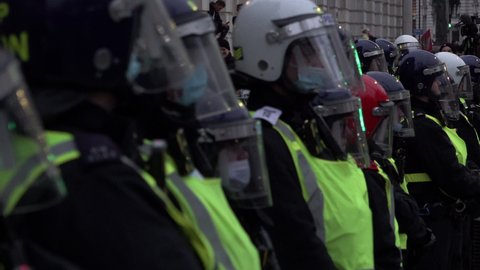 London , United Kingdom (UK) - 12 18 2021: A Unit Of Riot Police Wearing Helmets Stand In Line
