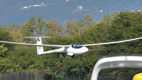 Thiene Italy OCTOBER, 16, 2021 Glider takes off towed with a rope. Gliders are the best of modern aerodynamics and fly silently without motor using thermal updrafts hot air. Jonker Sailplanes JS3