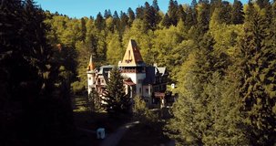 4K Aerial Footage of the Ancient Romanian Castle in the Heart of Awesome Autumn Green Forest, Pelisor
