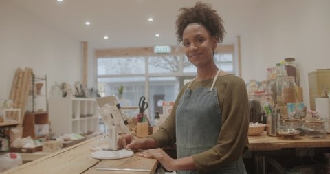 Portrait of Black Small Business Owner, Woman Working with Digital tablet in Store and looking at Camera