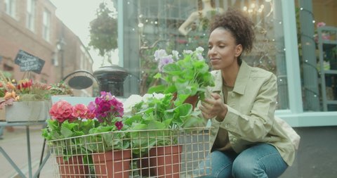 Female Customer smelling at local plant Florist Store