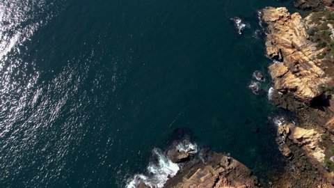 Cinematic aerial view to the rocky coastline Penobscot County, Maine, United States. Aerial top down view. Beautiful water texture. Nature background. Travel destination beautiful wild landscape. 