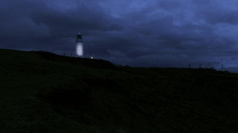 Lighthouse at night with it's shining light Stock Footage