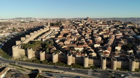 Aerial view of the walled city of Avila, from its west side, close to the Puerta de la Adaja; Avila's Cathedral at the end