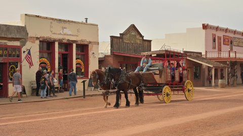 Tombstone , Arizona , United States - 12 22 2021: Horse-drawn carriage with tourists, Tombstone Arizona