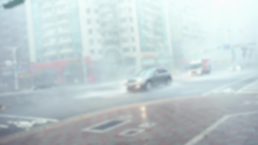 Blurred defocused Extreme Wind And Rain During A Super Typhoon Megi. A Street Taipei city with the strong hurricane winds. Car Traffic in asian road. | Shutterstock HD Video #1084835497