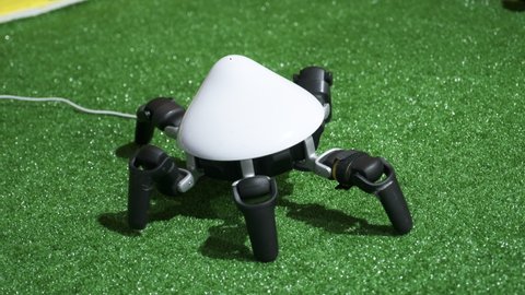 Futuristic robot having spider insect form and shape. Moving by robotic legs. Artificial Intelligence and modern technologies. No logo and intellectual property rights.
