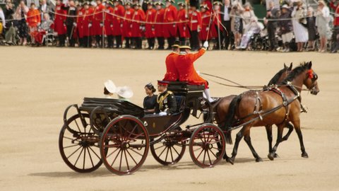LONDON, circa 2019 - Prince Harry and Meghan Markle travel in the Royal Landau during the official birthday of the Queen of England. Trooping the Colour is a military event dating back to 17th century