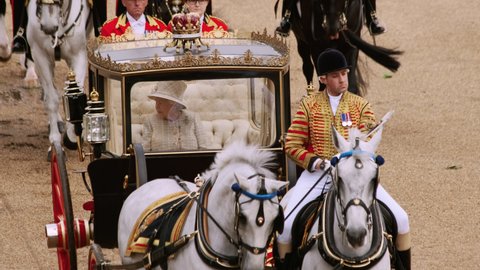 LONDON, circa 2019 - Queen Elizabeth II of England travels in the Scottish State Coach during Trooping the Color, a military ceremony in commemoration of her official birthday in Horse Guards, London