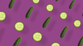 Colorful pattern of fresh cucumbers. Top view. Seamless pattern with cucumber slices. Pop art design. Realistic animation. 4K video motion