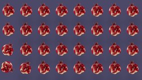 Colorful pattern of fresh pomegranates. Minimal tropical fruit concept. Seamless pattern with red pomegranate. Pop art design. Realistic animation. 4K video motion