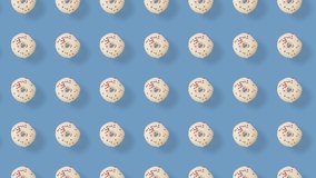 Colorful pattern of donuts isolated on blue background with shadows. Seamless pattern with donut. Doughnuts. Top view. Realistic animation. 4K video motion