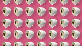 Colorful pattern of rolls of a white toilet paper isolated on pink background with shadows. Seamless pattern with toilet paper. Top view. Realistic animation. 4K video motion