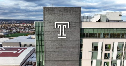 Philadelphia , PA , United States - 11 29 2021: Temple University public research school in Pennsylvania. Aerial pullback reveal shot. Temple T.