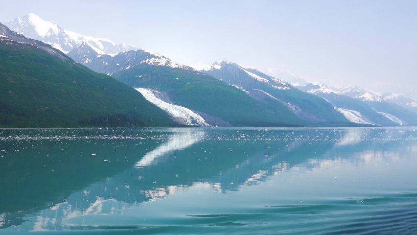 Cruise on the lake and see the icebergs. The lake is amber blue. The fjords of Alaska, unique natural landscapes. Alaska, USA. June 2019. | Shutterstock HD Video #1084850494