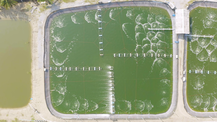 Aerial view of natural sea salt ponds, lake or sea. Farm field outdoor in traditional industry in Thailand. Asia culture. Agriculture irrigation. River reflection.