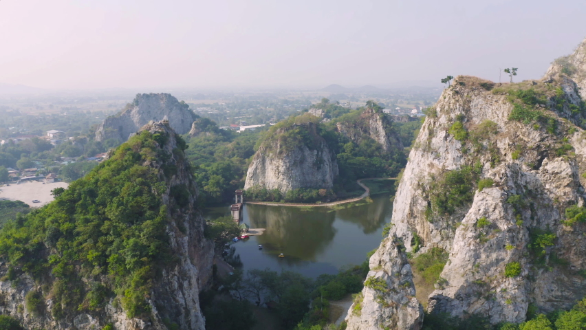 Aerial view of Khao Ngu Stone. National park with river lake, mountain valley hills, and tropical green forest trees at sunset in Ratchaburi, Thailand in travel trip. Natural landscape background.