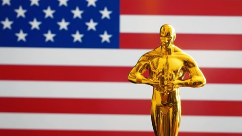 Hollywood Golden Oscar Academy award statue on american flag usa background. Success and victory concept.