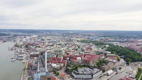 Inscription on video. Gothenburg, Sweden. Panorama of the city and the river Goeta Elv. The historical center of the city. Cloudy weather. Multicolored text appears and disappears, Aerial View