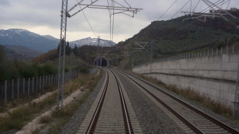 view from the last window of a railway passenger car, railway tracks stretching into the distance