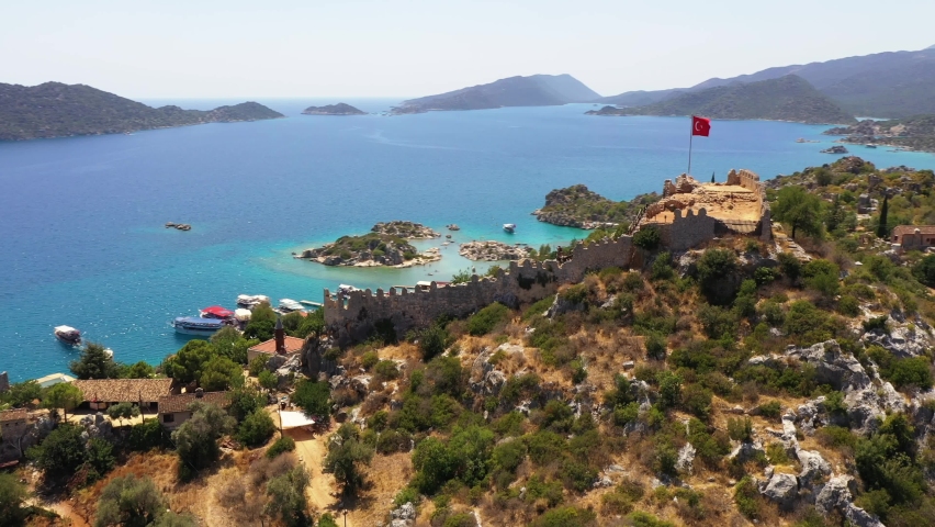 Kekova, also named Caravola, is a small Turkish island near Demre district of Antalya province which faces the villages of Kaleköy and Üçağız. Kekova has an area of 4.5 km² and is uninhabited.	 Royalty-Free Stock Footage #1084871908