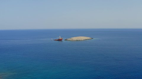 Shipwreck at Diakofti Kythira island Greece. aerial zoom video. Half sunk boat on the sea. 