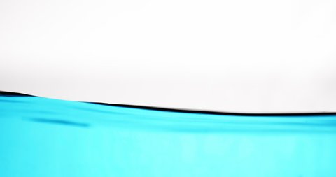 Close Up Lockdown Shot Of Blue Water Surface In Motion Against White Background