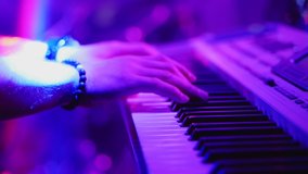Male hands playing on synthesizer piano. Band at concert stage playing music. - Powered by Shutterstock - Get 15% off with code: PIKWIZARD15