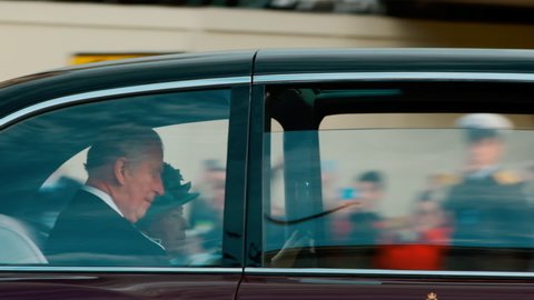 LONDON, circa 2019 - Slow motion shot of her Majesty Queen Elizabeth II and Prince Charles traveling in the State Limousine towards Westminster, London
