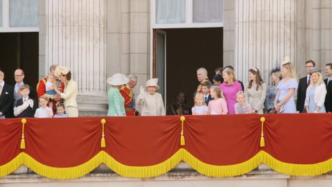 LONDON, circa 2019 - Queen Elizabeth II and the British Royal Family wave at the crowds from the balcony of Buckingham Palace in London, UK during the commemoration of her official birthday
