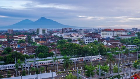 Yogyakarta, Indonesia - December 24 2021 : Morning view from Tugu Rail Station Jogja, with Merapi and Merbabu on the background