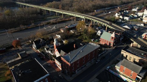 Brunswick, Maryland USA. Aerial View of Railroad, New Hope Methodist Church and Bridge Traffic Above Potomac River With Virginia State on Other SIde, Drone Shot