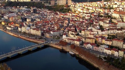 Aerial footage of coimbra city of Portugal with historical city center famous university and traffic on bridge over the river