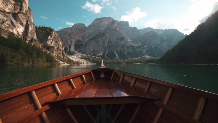 Wooden boat front view floating in Lake Braies Italian Alps on a beautiful sunny day in the summer  Royalty-Free Stock Footage #1084882351