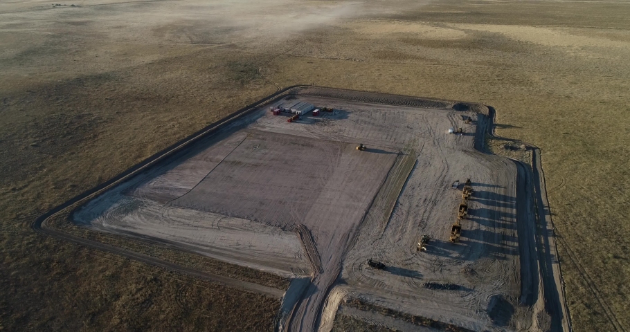 High altitude downshot over a mostly empty fracking pad during the late evening. 4K drone 60fps | Shutterstock HD Video #1084890667