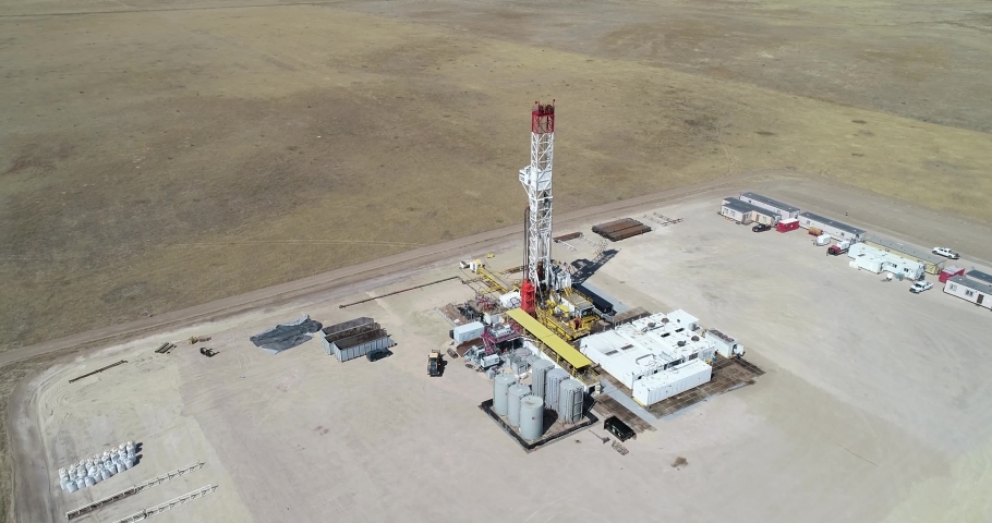 A three hundred foot half orbit of a large drilling operation revealing another rig in the same field. drone 4K 60fps | Shutterstock HD Video #1084891072