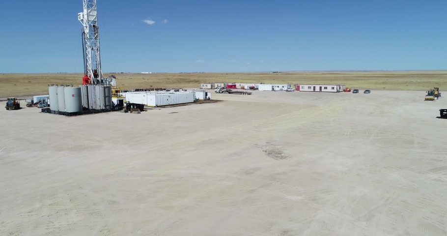 Drone flight over a fracking pad focusing on a semi truck and working coming out of a trailer. 4K drone 60FPS. | Shutterstock HD Video #1084892875