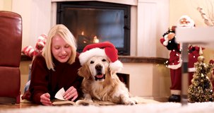 4k video footage of Young woman playing with her dog at home. They are preparing for Christmas celebration. Young beautiful woman cuddling with her cute dog at Christmas eve.
